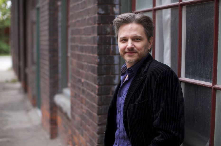 Person standing outside near brick building
